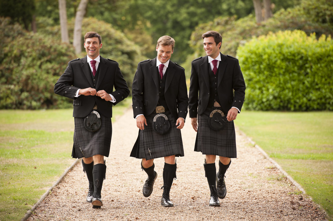 Three friends in matching kilt outfits